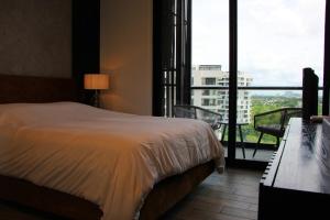 a hotel room with a bed and a large window at Panoramic Lake View Cabo Norte Mérida in Mérida +65 photos