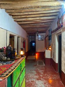 a hallway of a building with a room with a table at maison isabel in Boumalne Dades