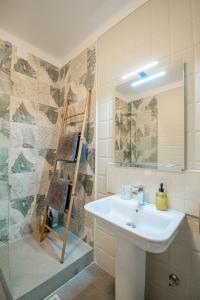 a bathroom with a sink and a mirror and a shower at Ufitness Villa Algarve in Vila Real de Santo António +37 photos