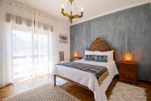 a bedroom with a large bed and a large window at Ufitness Villa Algarve in Vila Real de Santo António