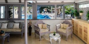 a living room with two chairs and a pool at Smaragdi in Perivolos