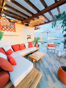 a living room with a couch and tables and a view of the ocean at NH Royal Urban Cartagena in Cartagena de Indias
