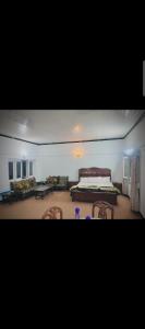 a bedroom with a bed and chairs in a room at DREAM LAND cottage in Abbottabad