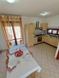 a kitchen with a table with plates on it at Casa Elena Floris in Teulada