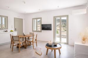 a kitchen and living room with a table and chairs at Villa Serenity Complex in Kampos Paros