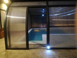een zwembad met uitzicht door een glazen deur bij CASA LA FÀBRICA in Horta de San Joan