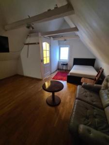 a living room with a couch and a bed and a table at Blu hus in Norra Kverrestad