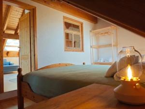 a bedroom with a bed and a table with a lamp at Chalet-Loft im Schwarzwaldhof Wutachblick in Bonndorf im Schwarzwald