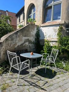 a table and two chairs and a table and chairs at Historisches Badehaus in Hoym