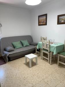 a living room with a couch and two chairs at Sanpau in Vejer de la Frontera