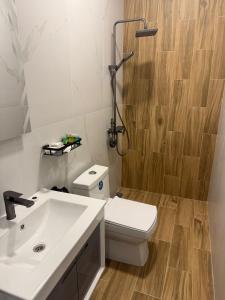 a bathroom with a white toilet and a sink at Davos hotel and tours in Pʼarakʼar +17 photos