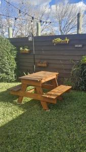 a wooden picnic table sitting on the grass at La Cañada in Colón