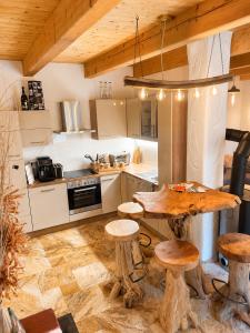 a kitchen with a wooden table and some stools at Kellerstöckl Gehringer in Guntersdorf