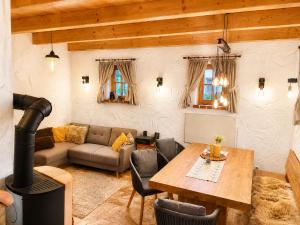 a living room with a couch and a table and a stove at Kellerstöckl Gehringer in Guntersdorf