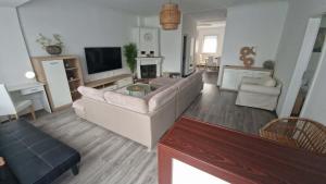 a living room with a couch and a tv at Green Terrace Residence in Zalaegerszeg +5 photos