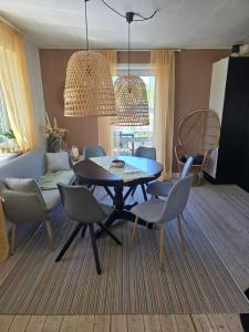a dining room with a table and chairs at Casa Tolne in Sindal +7 photos