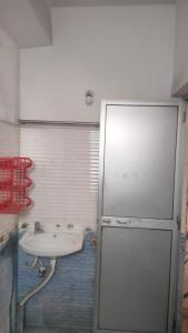 a bathroom with a sink and a white sink at OM Tower in Jamshedpur