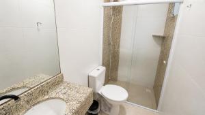 a small bathroom with a toilet and a shower at Van Gogh by OlaMar Bombinhas in Bombinhas