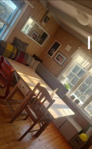 a table and chairs in a room with a window at Cabin and Guest house in Haugesund +17 photos