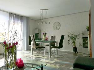 a living room with a dining room table and chairs at HarzApart-Goslar in Goslar