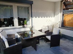 a dining table and chairs on a patio at HarzApart-Goslar in Goslar +13 photos