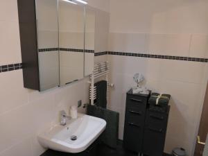 a bathroom with a sink and a mirror at HarzApart-Goslar in Goslar