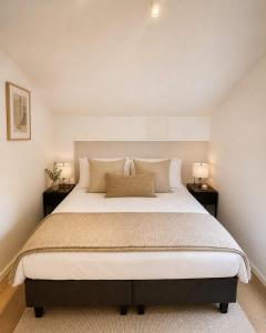 a bedroom with a large bed with two night stands at 70 Degrees North City Apartments in Tromsø
