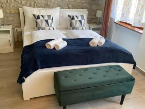 a bedroom with a large bed with two rolled towels at Vanellus in Balatongyörök