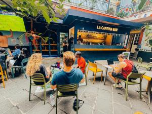 a group of people sitting at tables in a restaurant at Viajero CDMX Centro Hostel in Mexico City