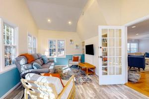 a living room with a couch and a tv at The Nest in Ocean Pines