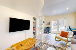 a living room with a flat screen tv on a wall at The Nest in Ocean Pines