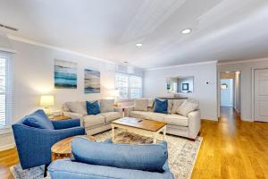 a living room with two couches and a table at The Nest in Ocean Pines