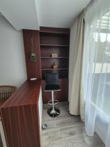 a room with a desk with a chair and a window at Green Terrace Residence in Zalaegerszeg