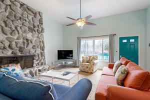 a living room with a couch and a stone wall at Teal Haven in Ocean Pines