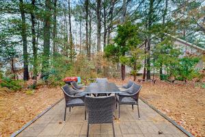 a table with chairs and a grill in a yard at Teal Haven in Ocean Pines