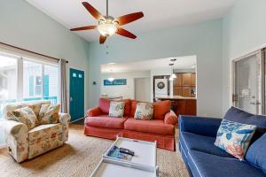 a living room with two couches and a ceiling fan at Teal Haven in Ocean Pines +20 photos