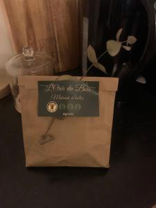 a paper bag with a sign for a bottle of wine at L Orée du Bois in Agnetz