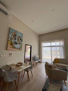 a living room with a couch and a table at Luxury Salalah Villa in Salalah