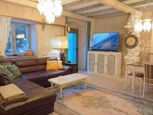 a living room with a couch and a tv at Villa Lido 145 m2 with pool in Krnica