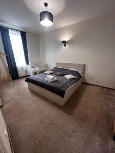 a bedroom with a bed in the middle of a room at Apartament 120m2 Centrum Ostródy in Ostróda