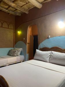 a bedroom with two beds in a room at maison isabel in Boumalne Dades