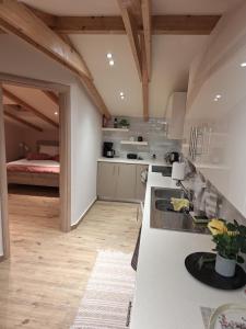 a kitchen with white counters and a bed in a room at ILIANA apartments in Preveza