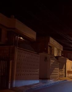 a night view of a building with a fence at Suite ejecutiva con Parqueo Privado in Latacunga