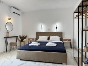 a bedroom with a bed with two pillows on it at Siblings by the Sea in Skala Marion