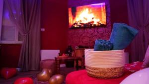 a living room with a fireplace and a basket at Le Rubis - Votre cocon d'orient in Calais +32 photos