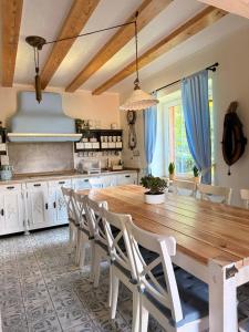 a kitchen with a wooden table and chairs at Dom Prowansalski in Jaworzynka