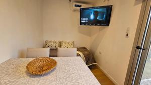 a room with a table and a television on the wall at Container home in San Rafael