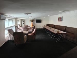 a conference room with a long table and chairs at Zeus Paradise Hotel Abuja in Abuja