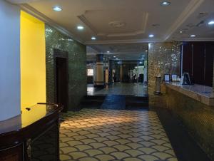 a lobby of a hotel with a yellow and green wall at Zeus Paradise Hotel Abuja in Abuja