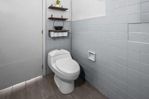 a bathroom with a white toilet in a stall at Your Home in León Top Location in León +18 photos